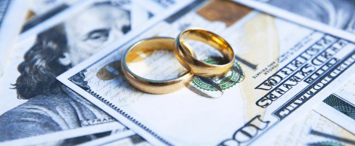 pair of wedding rings with dollar bills. Illustrating high net worth divorce in bradenton & sarasota florida