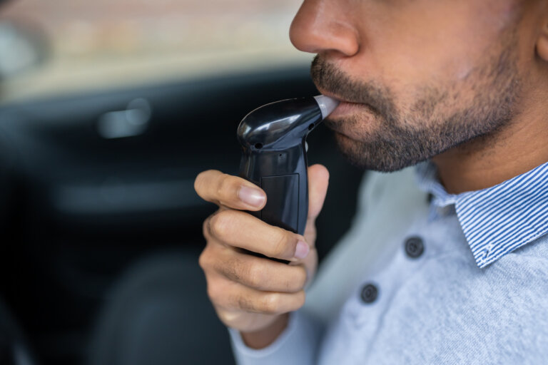 Man Sitting Inside Car Taking Alcohol Test