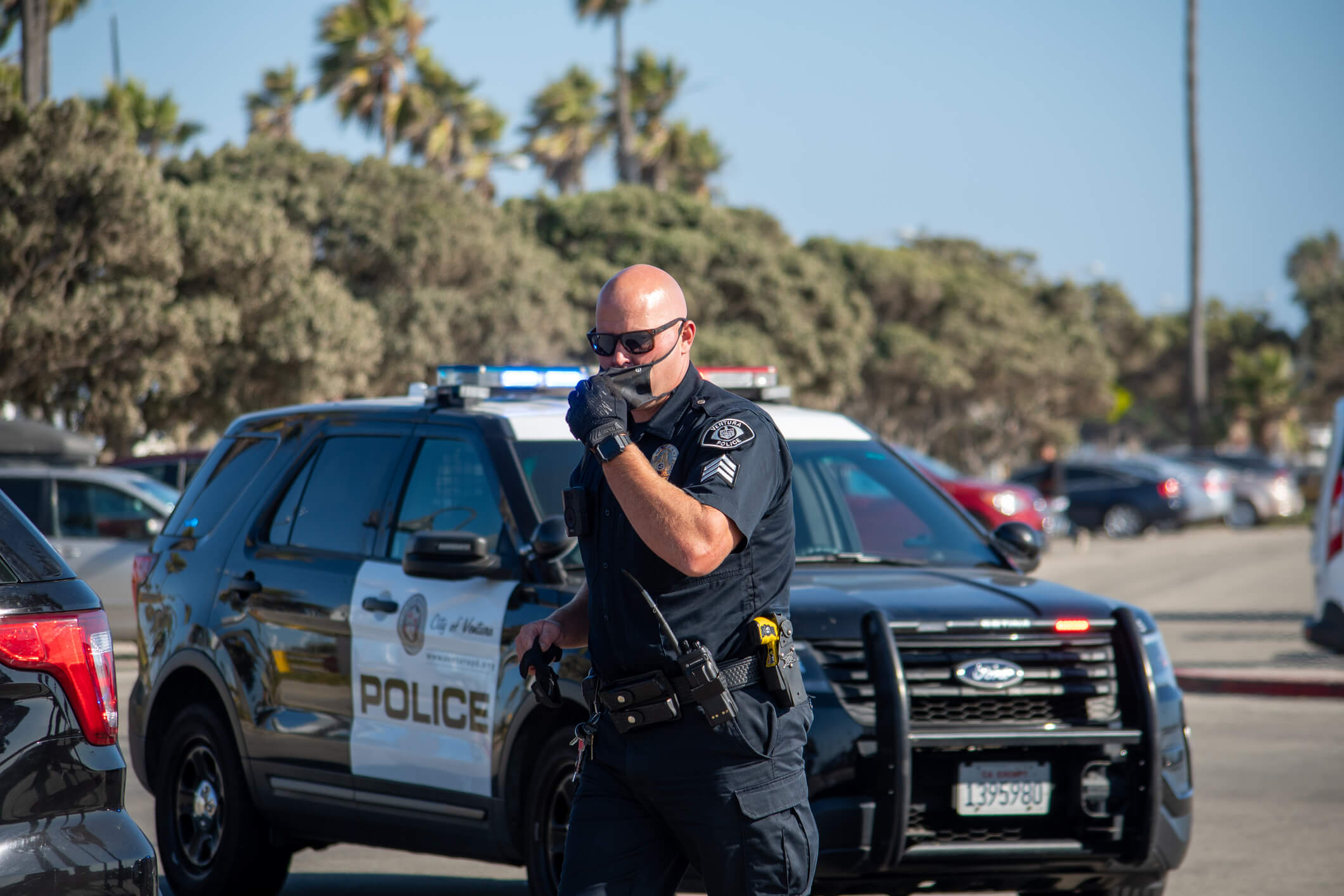 An officer arrives to conduct a search of a suspect's vehicle